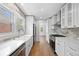 Modern kitchen with white cabinets, quartz countertops, and stainless steel appliances at 2140 S Washington St, Denver, CO 80210