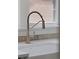 Close-up of kitchen faucet by farmhouse sink and countertop at 2140 S Washington St, Denver, CO 80210