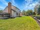 Well-manicured backyard with a large lawn, privacy fence, and mature landscaping at 7405 S Jackson Ct, Centennial, CO 80122
