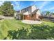 Expansive backyard featuring a covered patio and lush green lawn is perfect for outdoor entertaining at 7405 S Jackson Ct, Centennial, CO 80122