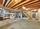 Partially finished basement featuring exposed wood beams, laundry, and storage shelves at 7405 S Jackson Ct, Centennial, CO 80122