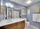 Elegant bathroom featuring a spacious vanity, large mirror, and modern fixtures at 7405 S Jackson Ct, Centennial, CO 80122