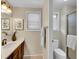 Well-lit bathroom featuring a wooden vanity, framed mirror, and separate toilet and shower areas at 7405 S Jackson Ct, Centennial, CO 80122