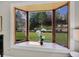 Large bay window offering views of the landscaped backyard, providing plenty of natural light to the living space at 7405 S Jackson Ct, Centennial, CO 80122
