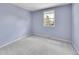 Neutral bedroom featuring plush carpet, a bright window and a closet at 7405 S Jackson Ct, Centennial, CO 80122