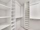 Bright, walk-in closet featuring built-in shelving and ample storage space at 7405 S Jackson Ct, Centennial, CO 80122