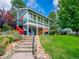 Community clubhouse featuring ample windows, manicured lawn and rock-lined landscape at 7405 S Jackson Ct, Centennial, CO 80122
