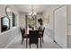 Formal dining room with a wooden table, seating for six, and a chandelier, perfect for Gathering gatherings at 7405 S Jackson Ct, Centennial, CO 80122