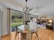 Bright dining area featuring wood floors, a glass table, and sliding doors to the backyard at 7405 S Jackson Ct, Centennial, CO 80122