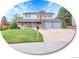 Charming two-story home boasts an inviting front porch, a manicured lawn, and a two-car garage at 7405 S Jackson Ct, Centennial, CO 80122
