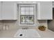 Bright kitchen features a large window above the sink, offering natural light and views of the backyard at 7405 S Jackson Ct, Centennial, CO 80122