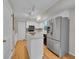 Well-lit kitchen with stainless steel appliances, a center island, and white cabinetry, offering ample storage at 7405 S Jackson Ct, Centennial, CO 80122