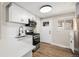 Modern kitchen with stainless steel appliances, white cabinetry, and quartz countertops at 1148 Rosemary St, Denver, CO 80220