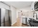 Bright kitchen with stainless steel appliances, and a view to the living area at 1148 Rosemary St, Denver, CO 80220