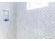 Bathroom featuring herringbone-patterned tile, a niche, and modern design at 2035 Highlands Dr, Breckenridge, CO 80424