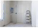 Unfinished bathroom with stylish tile work, window, ladder, and plumbing fixtures ready for final touches at 2035 Highlands Dr, Breckenridge, CO 80424