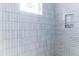 Modern bathroom featuring white subway tile walls, niche, and natural light from window at 2035 Highlands Dr, Breckenridge, CO 80424