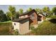 Contemporary home featuring unique stone accents, wood siding, nestled on a hillside surrounded by lush greenery at 2035 Highlands Dr, Breckenridge, CO 80424