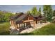 Beautifully designed home with natural wood exterior and stone base, surrounded by mountains and lush greenery at 2035 Highlands Dr, Breckenridge, CO 80424