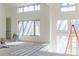 Bright living room with high ceilings, large windows, and a staircase still under construction at 2035 Highlands Dr, Breckenridge, CO 80424