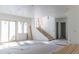 Unfinished open-concept living room with windows, a staircase, and natural light at 2035 Highlands Dr, Breckenridge, CO 80424