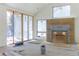 Living room with large sliding doors, fireplace, and windows offering plenty of natural light. Still under construction at 2035 Highlands Dr, Breckenridge, CO 80424