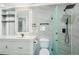 Beautiful bathroom featuring a marble wall, vanity, framed mirror and glass shower at 3184 S Heather Gardens Way # 406, Aurora, CO 80014