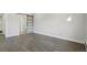 Bright bedroom featuring modern gray laminate flooring and a sliding barn door to the ensuite bathroom at 3184 S Heather Gardens Way # 406, Aurora, CO 80014