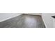 Close up of the gray laminate flooring in a light and airy bedroom with white baseboards and a radiator at 3184 S Heather Gardens Way # 406, Aurora, CO 80014