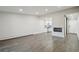 Bright, modern living area with an open layout, fireplace, hardwood floors, and a view of the kitchen at 3184 S Heather Gardens Way # 406, Aurora, CO 80014
