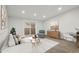 Cozy living room with modern furniture, light grey walls, wood-look floors, and balcony access at 3184 S Heather Gardens Way # 406, Aurora, CO 80014