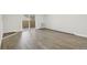 An empty room featuring sliding glass doors to the balcony and hardwood floors at 3184 S Heather Gardens Way # 406, Aurora, CO 80014
