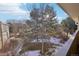 Balcony view of the neighborhood featuring mature trees and some remaining snow from a winter storm at 3184 S Heather Gardens Way # 406, Aurora, CO 80014