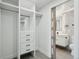 Open closet with built-in drawers leading to a bathroom at 3184 S Heather Gardens Way # 406, Aurora, CO 80014