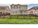Backyard view of a two-story home with a deck and fenced-in grass lawn at 2856 Penstemon Way, Castle Rock, CO 80109