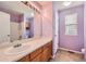 Lavender bathroom featuring a wide mirror above the vanity and a shower and tub at 2856 Penstemon Way, Castle Rock, CO 80109