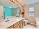 Double sink bathroom with granite counters and decorative lighting at 2856 Penstemon Way, Castle Rock, CO 80109