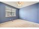 This bedroom features a ceiling fan, a window, and neutral carpet at 2856 Penstemon Way, Castle Rock, CO 80109