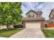 Two story home with brick veneer and two car garage on a sunny day at 2856 Penstemon Way, Castle Rock, CO 80109