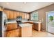Kitchen with wood cabinets, stainless steel appliances, and breakfast bar at 2856 Penstemon Way, Castle Rock, CO 80109