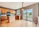 Bright kitchen with wood cabinets, island, and sliding glass doors to deck at 2856 Penstemon Way, Castle Rock, CO 80109