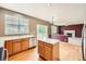 Open kitchen with island, stainless steel appliances and hardwood floors at 2856 Penstemon Way, Castle Rock, CO 80109