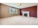 Living room features a fireplace, a large window, and neutral carpet at 2856 Penstemon Way, Castle Rock, CO 80109