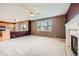 Open concept living room features fireplace, large window and bar top access to kitchen at 2856 Penstemon Way, Castle Rock, CO 80109