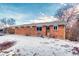 Brick ranch home with backyard, partially covered in snow at 13643 E Exposition Ave, Aurora, CO 80012