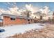 Brick ranch home with backyard, partially covered in snow at 13643 E Exposition Ave, Aurora, CO 80012