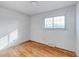 Bright bedroom with hardwood floors and a large window at 13643 E Exposition Ave, Aurora, CO 80012