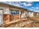 House exterior showcasing a brick facade and a front porch at 13643 E Exposition Ave, Aurora, CO 80012