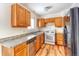 Kitchen with wood cabinets, granite countertops, and stainless steel appliances at 13643 E Exposition Ave, Aurora, CO 80012