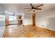 Open living room with hardwood floors and a view into the kitchen area at 13643 E Exposition Ave, Aurora, CO 80012